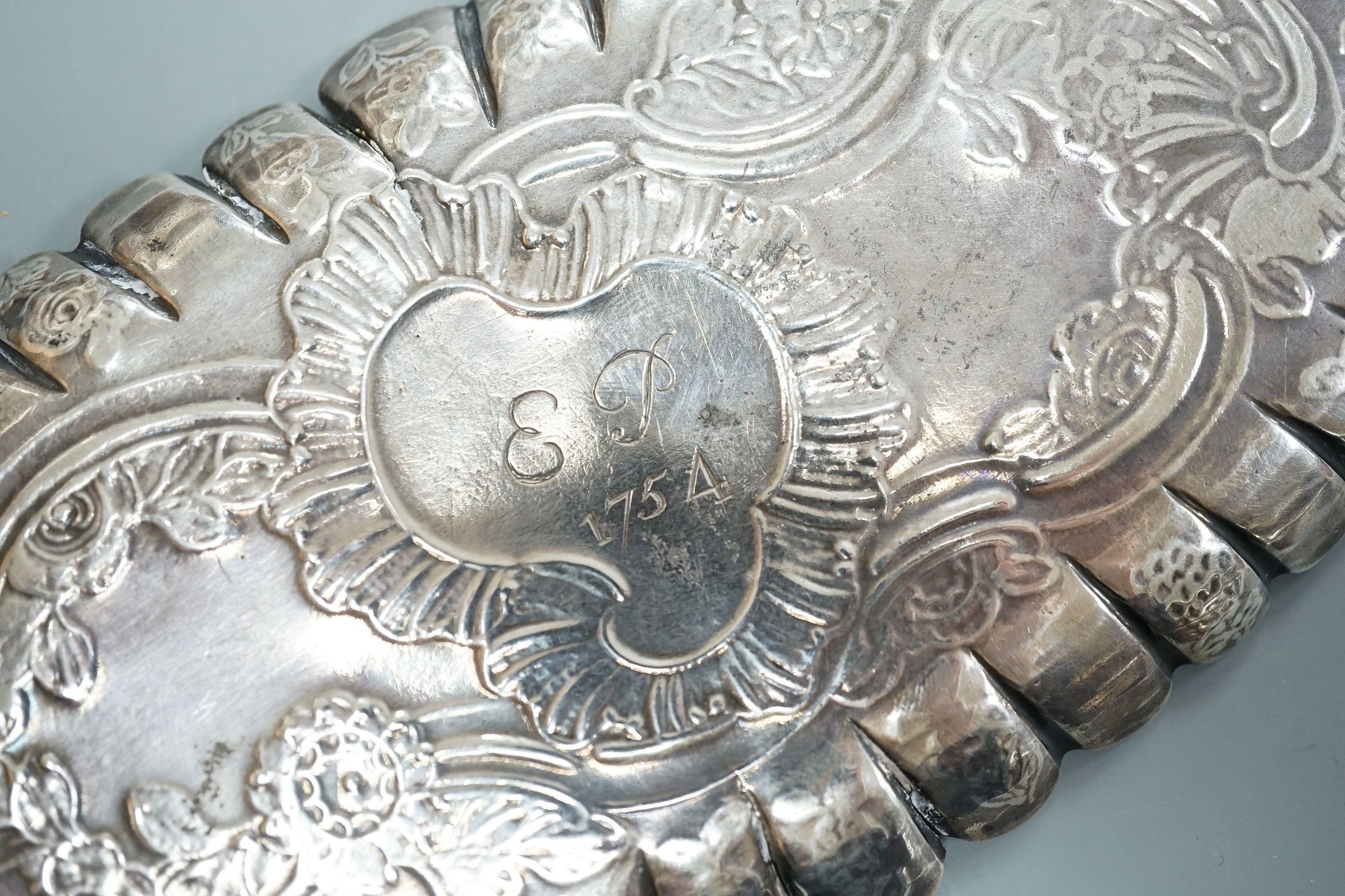 A mid 18th century Irish embossed silver oval pin tray, with engraved date and initials, maker ID?, Dublin, circa 1750, 16.4cm, 74 grams (a.f.)